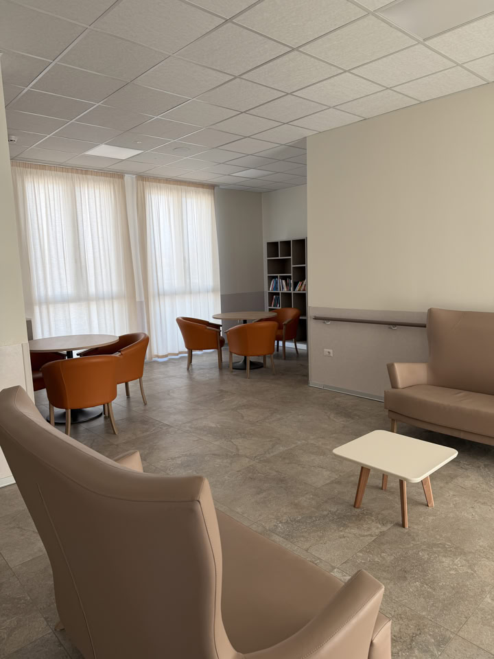 Sala per servizi alla persona con postazioni dotate di specchio, sedie e lavatesta